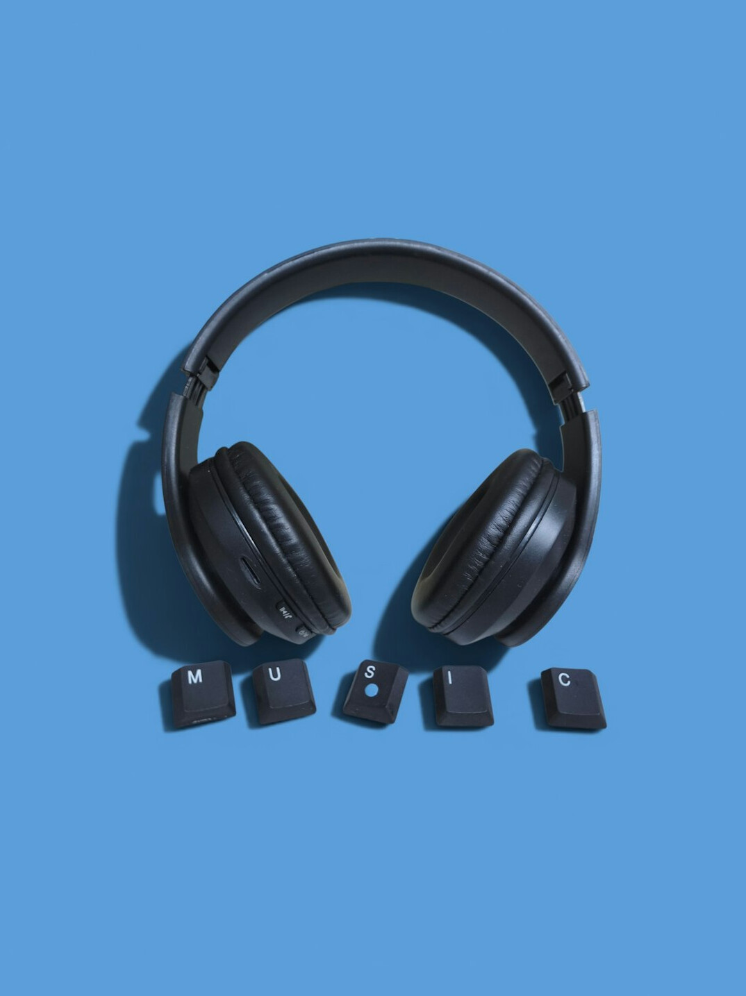Studio headphones and intercom equipment on a production desk