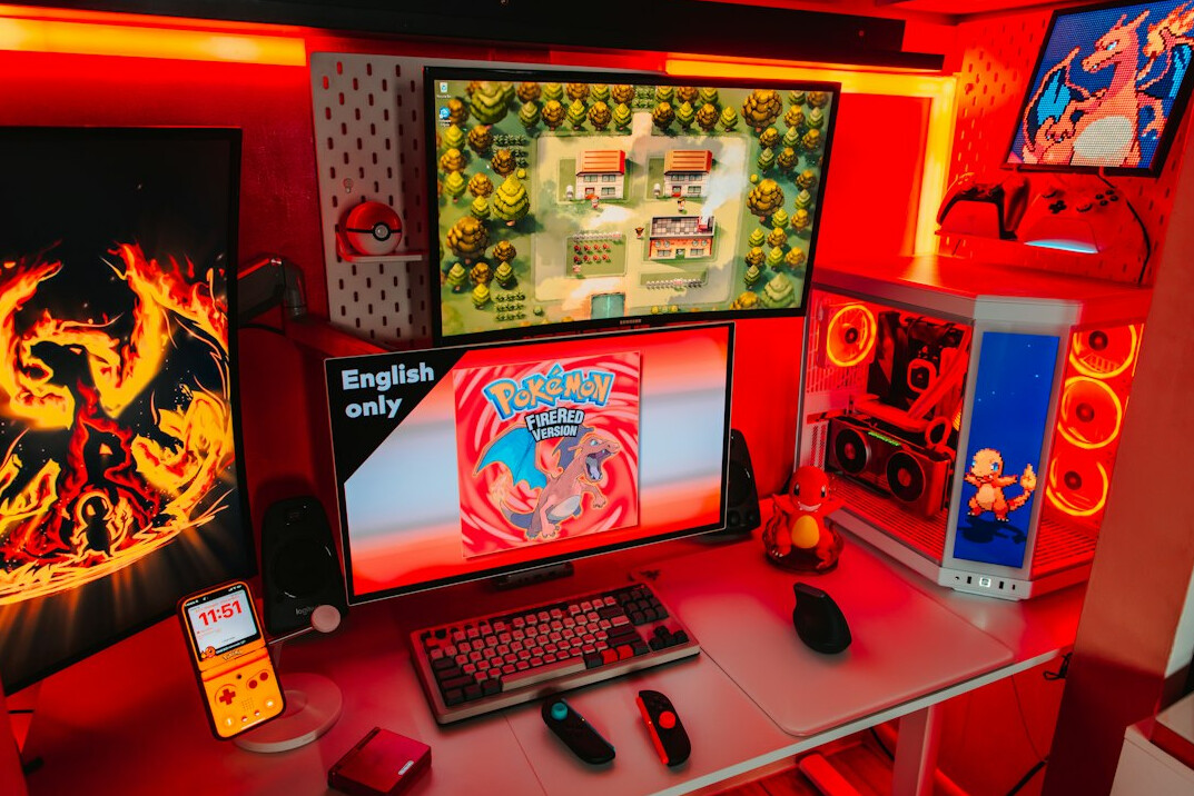 Video editing workstation with several monitors displaying graphics and timelines