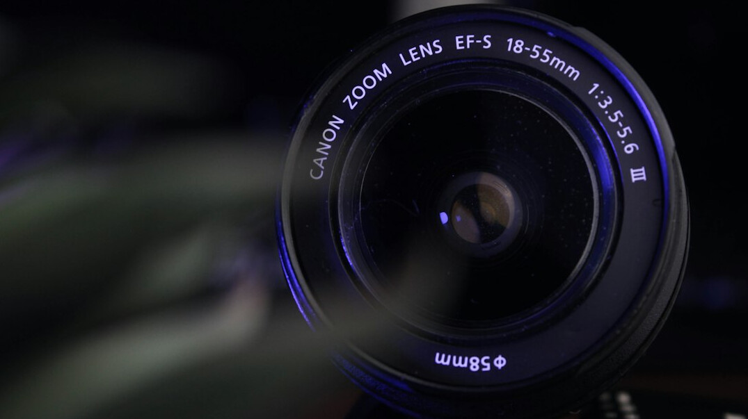 Camera lens close-up with studio reflections