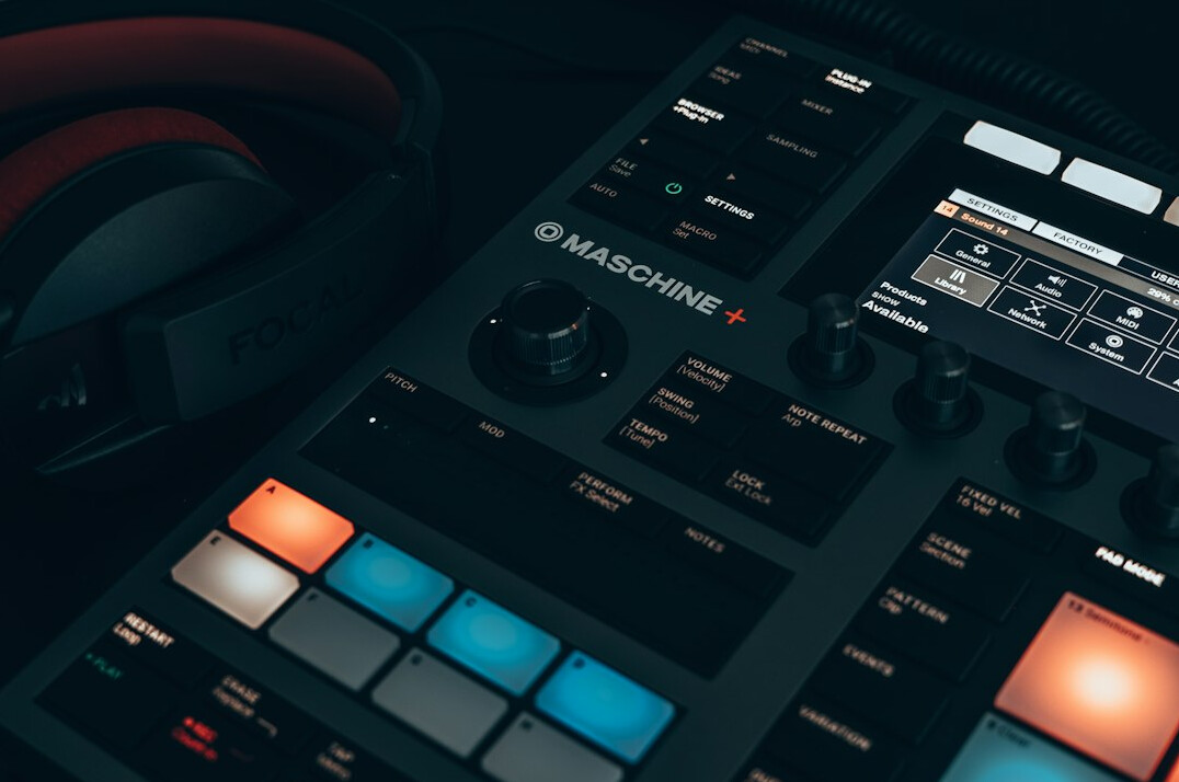 Mixing console with glowing faders in a dark studio